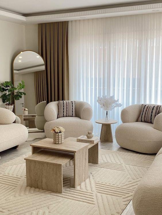 Bright modern living room with arched mirror and travertine tables